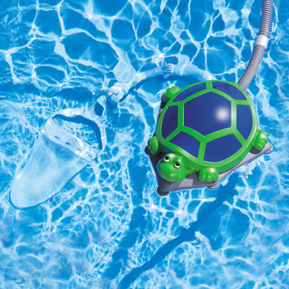 Polaris Turbo Turtle floating in a pool with hose and underwater debris bag visible